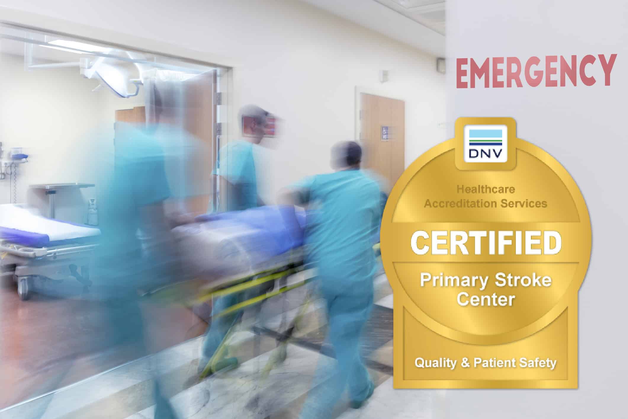 Medical team transporting a patient in an emergency room with DNV certification badge.