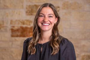 Portrait of Alissa Tolbert, PA, smiling in front of a brick wall.