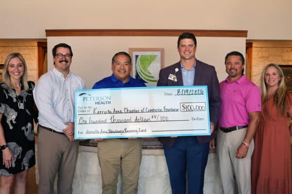 Peterson Health representatives present a $100,000 donation check to Kerrville Chamber of Commerce.