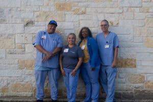 Healthcare team standing outside in scrubs for home care services.
