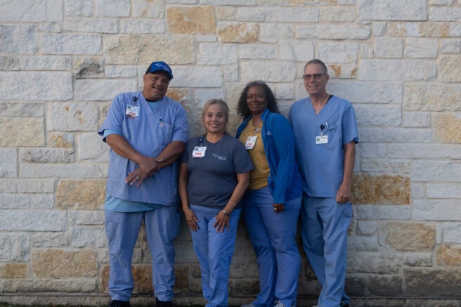 Healthcare team standing outside in scrubs for home care services.